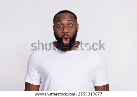 Photo of charming impressed guy dressed casual t-shirt big eyes isolated white color background