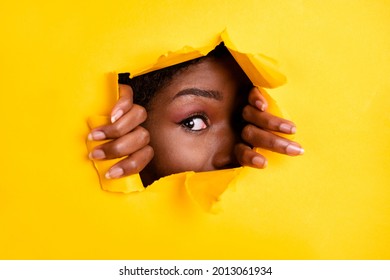 Photo of charming interested woman ripped torn blank space look through bright yellow color background