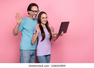 Photo Of Charming Married Couple Have Video Call With Family Wave Hand Say Hi Isolated On Pink Color Background