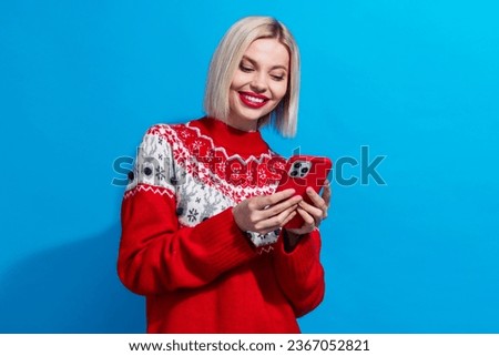 Photo of charming person use smart phone chatting empty space wear x-mas sweater isolated on blue color background