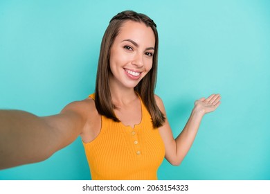 Photo of charming positive happy woman make selfie invite you hand empty space isolated on teal color background - Powered by Shutterstock