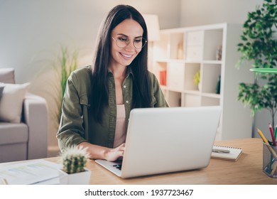 Photo Of Charming Positive Person Sit Behind Desktop Look Use Laptop Have Good Mood Working Home Indoors