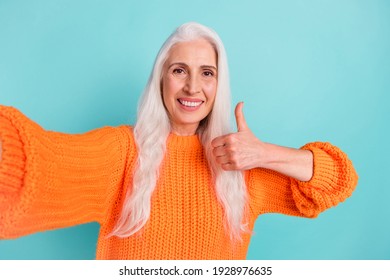 Photo of charming pretty old lady make thumb-up take camera selfie smile promoter isolated on teal color background