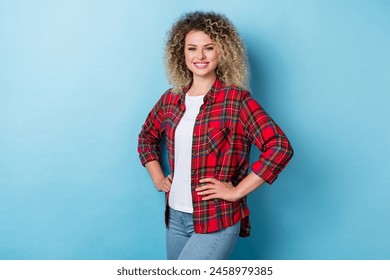 Photo of charming pretty positive confident lady posing hands hips wear checkered shirt isolated blue color background - Powered by Shutterstock