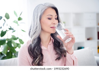 Photo of charming pretty positive old woman drink water glass thirsty indoors inside house home apartment - Powered by Shutterstock