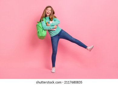 Photo of charming school girl dressed teal pullover embracing supplies isolated pink color background