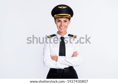 Photo of charming self-assured pilot lady crossed hands wear hat aviator uniform isolated white color background