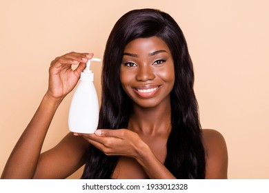 Photo of charming sensual lady hold shampoo soap bottle look camera shiny white smile isolated beige background