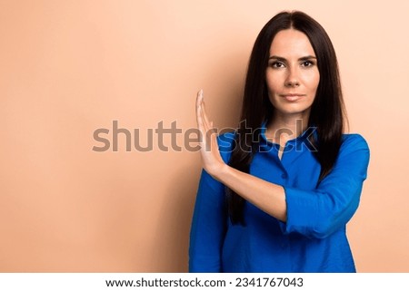 Photo of charming serious woman wear trendy clothes avoid product demonstrate stop symbol empty space isolated on beige color background
