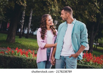 Photo Of Charming Shiny Boyfriend Girlfriend Wear Casual Outfits Walking Holding Hands Arms Enjoying Sunny Weather Outdoors Garden