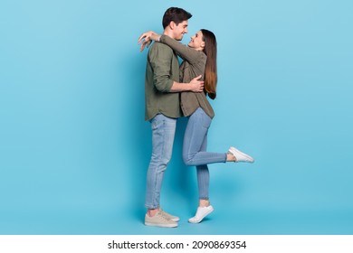 Photo of charming shiny young guy woman dressed khaki shirts smiling embracing isolated blue color background - Powered by Shutterstock