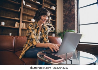 Photo Of Charming Shiny Young Woman Dressed Plaid Shirt Sitting Sofa Chatting Modern Gadget Indoors Workstation