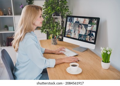 Photo of charming sweet age woman dressed blue shirt sitting table having video conference modern gadget smiling indoors home room - Shutterstock ID 2084561917