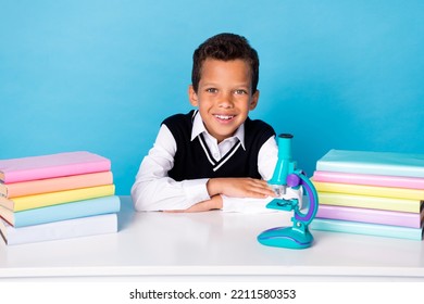 Photo Of Charming Sweet Little Guy Dressed Black Vest Sitting Table Ready For Chemistry Subject Isolated Blue Color Background