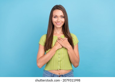 Photo Of Charming Young Happy Woman Hold Hands Chest Honest Person Smile Isolated On Blue Color Background