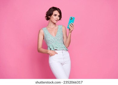 Photo of charming young nice lady bob brown hairstyle texting smartphone her twitter post account user isolated on pink color background
