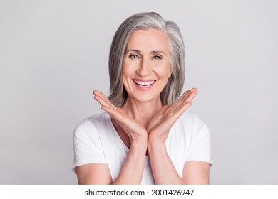 Photo of cheerful aged woman happy positive toothy smile wear t-shirt isolated over grey color background