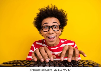 Photo of cheerful astonished man open mouth toothy smile keyboard typing isolated on yellow color background - Shutterstock ID 2311379047