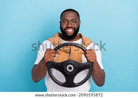 Photo of cheerful auto rider hold steering wheel wear white t-shirt jumper front-tie isolated blue color background