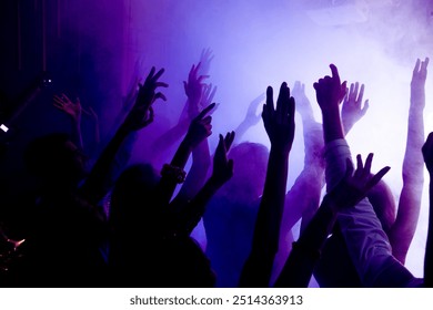 Photo of cheerful bachelors millennial fellows enjoy famous celebrity music raise hands up on disco event with violet neon light - Powered by Shutterstock