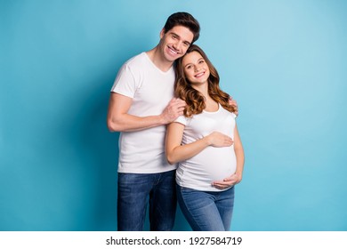 Photo of cheerful charming adorable family waiting baby hugging arms hands tummy isolated blue color background