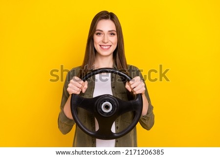 Photo of cheerful charming lady hold steering wheel go on ride summer vacation isolated on yellow color background