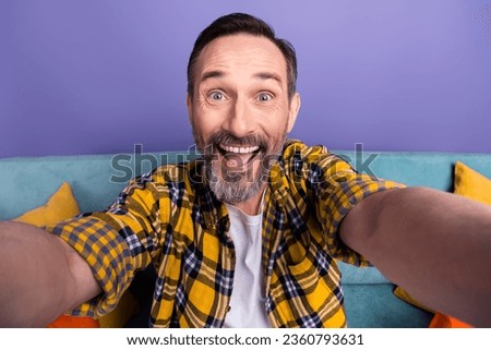 Photo of cheerful crazy man wear stylish checkered clothes take selfie recommend furniture store isolated on purple color background