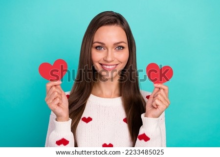 Photo of cheerful cute person toothy smile hands hold small heart symbols isolated on emerald color background