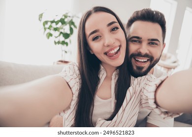 Photo of cheerful cute young couple enjoy weekend couple wife husband take selfie photo playful buy new apartment indoors inside house home - Powered by Shutterstock