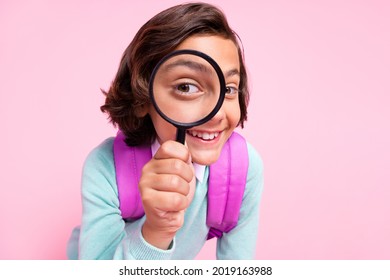 Photo Of Cheerful Detective Boy Hold Loupe Look Watch See Enlarge Eye Wear Bag Teal Shirt Isolated Pink Color Background