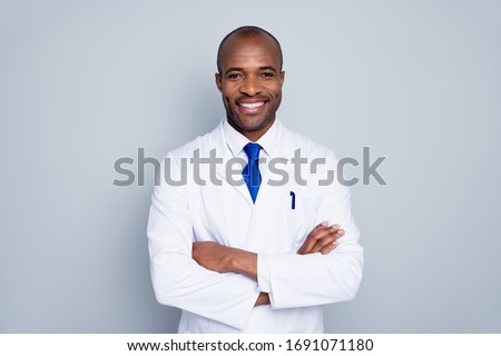 Photo of cheerful doctor dark skin guy virologist agent corona virus seminar conference arms crossed pandemic virus expert wear white lab coat tie isolated grey color background