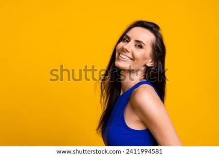 Photo of cheerful dreamy lady dressed blue top smiling empty space isolated yellow color background