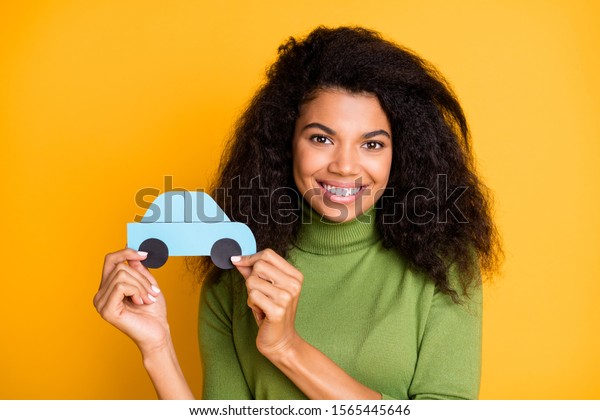 Photo of cheerful fun\
positive cute pretty nice girlfriend adverting you auto services\
her company provides holding paper car with hands isolated vivid\
color background