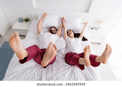 Photo of cheerful funky husband wife nightwear jumping falling bed indoors house bedroom - Powered by Shutterstock