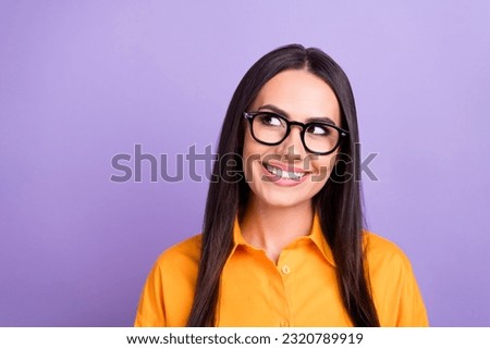 Photo of cheerful funny cute girl straight hairdo dressed yellow shirt look at offer empty space isolated on purple color background