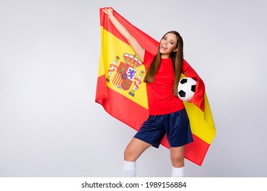 Photo of cheerful funny joyful lady support soccer team league carry spain national flag final game hold ball wear football uniform t-shirt shorts long knee socks isolated white color background