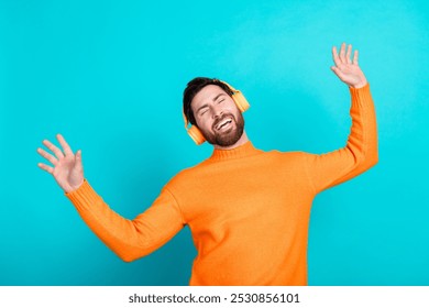 Photo of cheerful funny nice man wear trendy clothes listen music isolated on cyan color background - Powered by Shutterstock