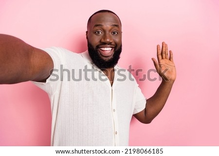 Photo of cheerful funny person take selfie arm palm waving hi isolated on pink color background