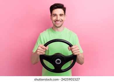 Photo of cheerful handsome young guy driving steering wheel enjoying comfort volkswagen ag automobile isolated on pink color background