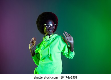 Photo Of Cheerful Lady Dance Enjoy Wear Headphones Glasses Sweatshirt Isolated Gradient Green Neon Background