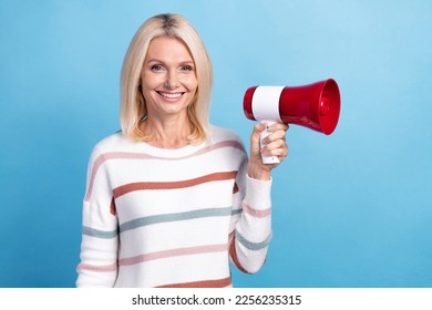 Photo of cheerful lady hand hold bullhorn tell news low prices black friday propositions empty space isolated on blue color background - Shutterstock ID 2256235315