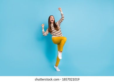 Photo of cheerful lucky sweet young lady wear ornament sweater rising fists isolated blue color background