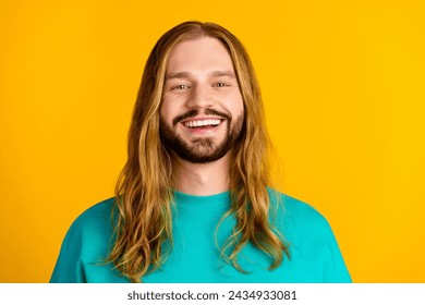 Photo of cheerful nice young man beaming smile nice wavy hairstyle empty space isolated on yellow color background - Powered by Shutterstock