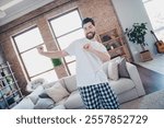 Photo of cheerful optimistic man wear pajama having fun dancing alone living room modern loft interior indoors