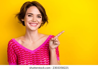 Photo of cheerful optimistic nice girl dressed off shoulder shirt indicating at sale empty space isolated on yellow color background - Shutterstock ID 2303358221