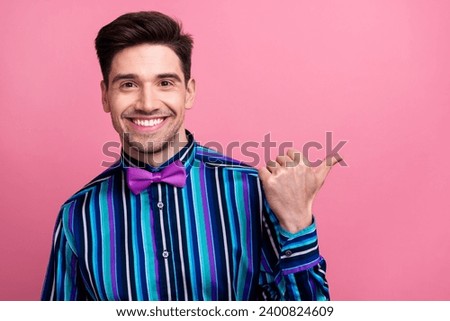 Photo of cheerful person toothy smile indicate thumb finger empty space offer isolated on pink color background