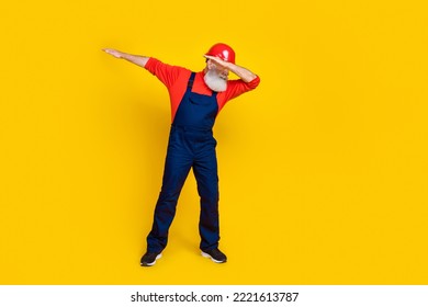 Photo Of Cheerful Positive Age Man Workwear Overall Red Hard Hat Dancing Having Fun Isolated Yellow Color Background