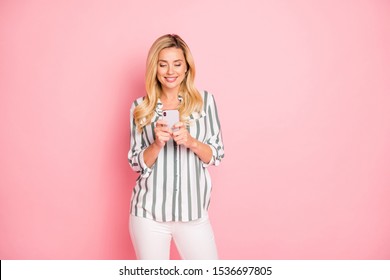 Photo Of Cheerful Positive Cute Nice Attractive Mature Woman Wearing White Trousers Pants Smiling Toothily Browsing Through Telephone Isolated Pastel Color Background