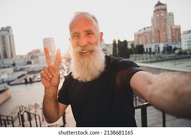 Photo of cheerful positive friendly retired trainer influencer take selfie show v-sign wear t-shirt urban town outdoors. - Powered by Shutterstock