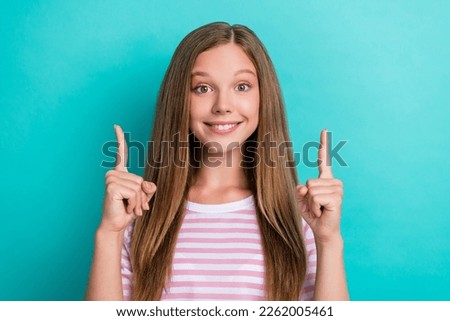 Photo of cheerful positive girl toothy smile indicate fingers up empty space isolated on teal color background